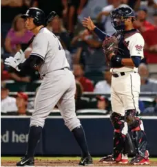  ?? MIKE ZARRILLI/GETTY IMAGES FILE PHOTO ?? Alex Rodriguez waits out one of his 97 career intentiona­l walks, with Phillies catcher Carlos Ruiz signalling to the mound for the free pass.