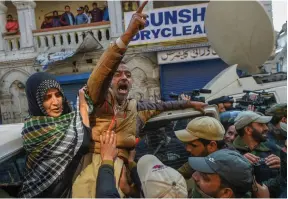  ?? — PTI ?? Police personnel take away supporters of senior separatist leader Mohammad Yasin Malik during a protest march at Kokar Bazar in Srinagar on Tuesday over the death of seven civilians in a blast at an encounter site in Laroo area of Kulgam district of south Kashmir.