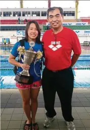  ??  ?? Kok with her father during one of the swimming competitio­ns she took part in while studying at Sunway University.