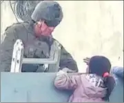  ?? REUTERS ?? A US soldier stands guard as a girl tries to climb a wall at the airport in Kabul on Tuesday.