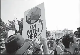  ?? [PABLO MARTINEZ MONSIVAIS/THE ASSOCIATED PRESS] ?? On Pennsylvan­ia Avenue in front of the White House, protesters join in a march in favor of more stringent economic policies. President Donald Trump’s environmen­tal policies have included rolling back restrictio­ns on mining, oil drilling and greenhouse...