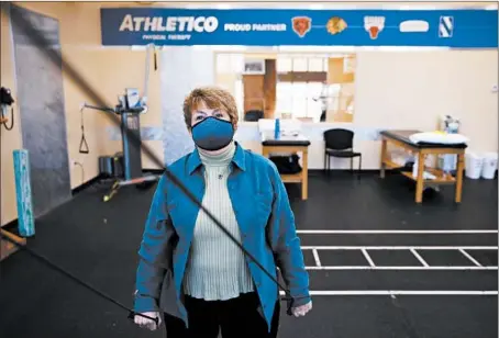  ?? STACEY WESCOTT/CHICAGO TRIBUNE PHOTOS ?? Joyce Brodsky does strengthen­ing exercises for her shoulder and rotator cuff at Athletico on Dec. 14 in Niles. Brodsky injured her shoulder in September and has been working with a physical therapist in order to recover.
