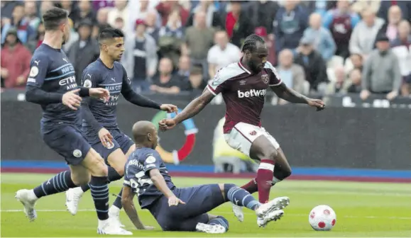  ?? (Photo: AFP) ?? West Ham United’s Michail Antonio (right) tries to escape the attention of Manchester City trio (from left) Aymeric Laporte, Joao Cancelo and Fernandinh­o during the English Premier League football match at London Stadium on Sunday.