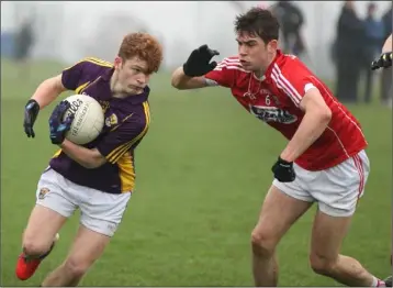  ??  ?? Dylan Lyne of Wexford tries to find a way past Peter O’Driscoll (Cork) during Saturday’s clash.