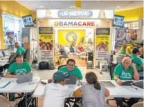  ?? Angel Valentin / New York Times file ?? Customers check out Sunshine Health and Life Advisors in Miami in November. The insurance industry has said uncertaint­y about Obamacare has made it difficult to predict rates.