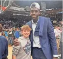  ?? PROVIDED BY TANYA ELLINGWOOD ?? Rylan Ellingwood and UConn director of player developmen­t Mamadou Diarra celebrate after a win last week.