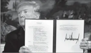  ?? DOUG MILLS / THE NEW YORK TIMES ?? President Donald Trump signs a presidenti­al memorandum on the Iran nuclear deal in the Diplomatic Room of the White House on May 8.