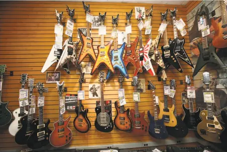  ?? Chester Higgins Jr. / New York Times 2009 ?? Guitars grace a display wall at Manny’s Music in Manhattan, whose longtime owner, Henry Goldrich, died last month.