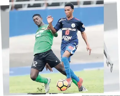  ?? RICARDO MAKYN/MULTIMEDIA PHOTO EDITOR ?? Diandre Borrowes (left) of Calabar High is beaten by Jamaica College’s Tyreek Magee in their Walker Cup semi-final at the National Stadium yesterday. JC won 6-1, with Magee getting one of the goals.