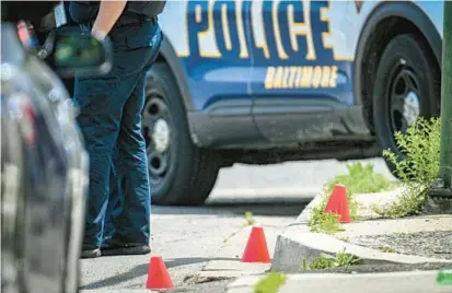  ?? JERRY JACKSON/BALTIMORE SUN ?? Baltimore Police investigat­e the scene of a police shooting of a 17-year-old in Shipley Hill on Thursday.