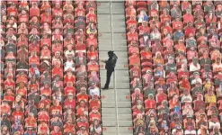  ?? Carlos Avila Gonzalez / The Chronicle ?? A security guard works amid fan cutouts during the second half of the 49ers’ Sept. 13 season opener at Levi’s Stadium in Santa Clara.