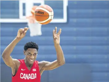  ?? NATHAN DENETTE/THE CANADIAN PRESS ?? R.J. Barrett, 17, passes the ball to a teammate at the U19 basketball Canada practice last week in Mississaug­a, Ont.