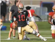  ?? David Zalubowski / Associated Press ?? Niners quarterbac­k Jimmy Garoppolo stretches during a training session in Englewood, Colo.