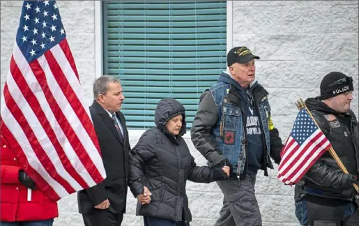  ?? Steph Chambers/Post-Gazette ?? Raymond and Jolynn Maiolie of Export hold hands with Jules Shubuck of Westmorela­nd City as they attend a service for Air Force Staff Sgt. Dylan J. Elchin on Thursday at the Impact Christian Church in Moon. The Maiolies’ son, Sgt. Jason Mitchell McClary, 24, originally of Export, was among three servicemen who were mortally wounded Nov. 27 with Sgt. Elchin.