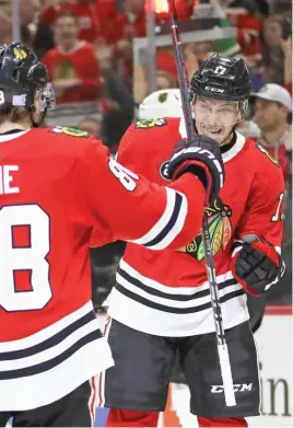  ?? GETTY IMAGES ?? Dylan Strome (right) celebrates with Patrick Kane after his first goal with the Hawks on Tuesday against the Golden Knights at the United Center.