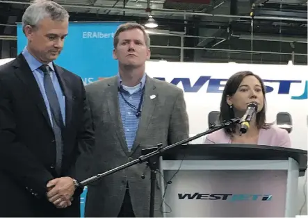  ?? JAMES WOOD ?? Environmen­t Minister Shannon Phillips announced the BEST Challenge at the WestJet Encore hangar in northeast Calgary on Wednesday. With Phillips are Emissions Reduction Alberta CEO Steve MacDonald, left, and WestJet vice-president Mike McNaney.