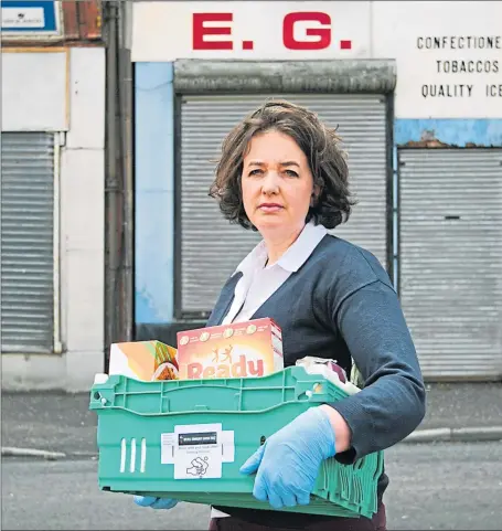  ??  ?? Charity manager Laura Reilly at Crawfords Burn Community Centre in Greenock with food box for vulnerable