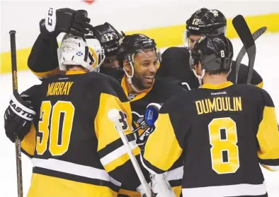  ?? | GENE J. PUSKAR/AP ?? The Penguins celebrate Saturday after defeating the Rangers to reach the second round of the playoffs.