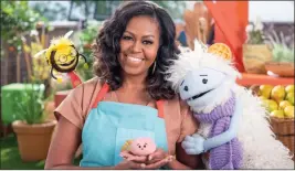  ??  ?? The Associated Press
Michelle Obama with Busy, a bee puppet, left, Mochi, a pink round puppet, and Waffles, a furry puppet on the set of the children’s series “Waffles + Mochi.”