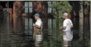  ?? THE ASSOCIATED PRESS ?? Men walk through a flooded neighborho­od in Lumberton, N.C., Monday, in the aftermath of Hurricane Florence.