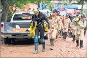  ?? LINH PHAM — GETTY IMAGES ?? British cave diver John Volanthen walks out from Tham Luang Nang Non cave in a wetsuit. He was one of three divers to discover the youths.