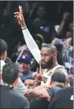  ?? AP ?? LeBron James soaks up the adulation after his latest milestone in Los Angeles on Saturday night.