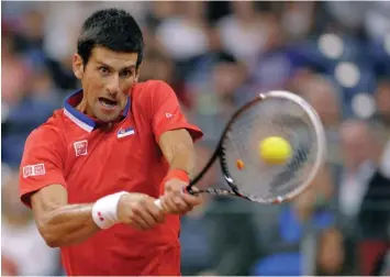  ?? AGENCE FRANCE PRESSE ?? Serbia's Novak Djokovic returns the ball to Canada's Milos Raoni during a Davis Cup World Group semifinal match at the Belgrade Arena.
