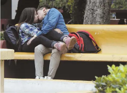  ?? AP PHOTOS ?? AMOROUS ATTENTION: Couples, above and below, kiss in a public park in Guadalajar­a, Mexico. It’s now easier to get frisky in public in Guadalajar­a as the city has made it harder to police sexual activity in public.