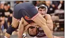  ?? KYLE FRANKO — TRENTONIAN PHOTO ?? Rider’s Jesse Dellavecch­ia, right, holds on to Rutgers’ Mike Vanschenkb­rill, left, during their 157-pound bout last season.