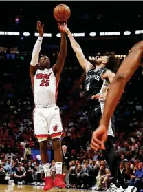  ?? Brynn Anderson / Associated Press ?? Heat rookie Kendrick Nunn launches a jumper over Derrick White on his way to a game-high 33 points.