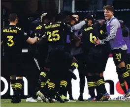  ?? EMILEE CHINN — GETTY IMAGES ?? The Crew mob Artur after he scored the game’s only goal against New England in the Eastern Conference final, sending the team to the MLS Cup.