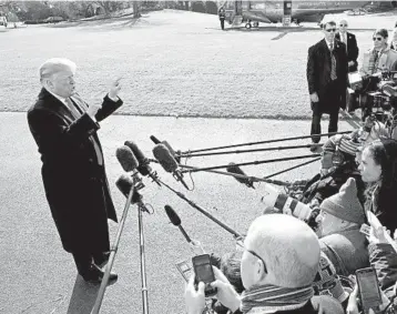  ?? WIN MCNAMEE/GETTY ?? President Trump speaks to the news media while departing the White House on Thursday.