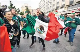  ?? Hector Vivas Getty Images ?? MEXICAN fans in Moscow celebrate winning the 2026 World Cup with the U.S. and Canada. Mexico and Canada will each host 10 of the 80 tournament games.