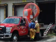  ?? Above photo by Russ Olivo; right photo by Matthew Gregoire ?? ABOVE: A truck-mounted fan known as a ‘Big Tempest,’ at the scene courtesy of the Sutton (Mass.) Fire Department, is used to clear some of the heavy smoke that permeated the complex.