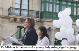  ??  ?? Dr Miriam Sciberras and a young lady using sign language