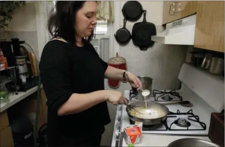  ?? THE ASSOCIATED PRESS ?? Ruthy Kirwan, of Percolate Kitchen, whisks heavy cream into the roux as she prepares a bechamel sauce for her version of the classic Thanksgivi­ng favorite Green Been Casserole in her apartment kitchen in the Queens borough of New York. Before actors...