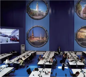  ??  ?? Journalist­s gear up to report on the G20 Summit at the press center in Hamburg, Germany, on July 6