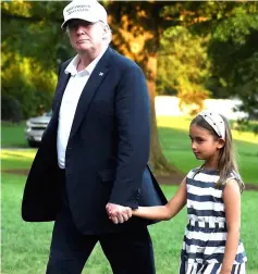  ??  ?? Trump walks hand-in-hand with granddaugh­ter Arabella as they exit Marine One helicopter, returning from a weekend at his Bedministe­r, New Jersey golf club, to the White House, Washington, DC. — Reuters photo