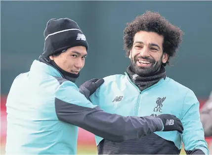  ?? REUTERS ?? Liverpool’s Takumi Minamino, left, and Mohamed Salah attend a training session yesterday.