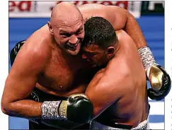  ??  ?? GETTING COSY: Fury is held by Seferi before the Albanian was pulled out of the contest after only four rounds in Manchester