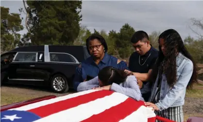  ??  ?? Lila Blanks is comforted by her friend Nikki Wyatt, her son Brandon Danas, 17, and her daughter Bryanna Danas, 14, at the casket of her husband, Gregory Blanks, 50, who died from complicati­ons from Covid-19 in Texas, on 26 January 2021. Photograph: Callaghan O’Hare/ Reuters