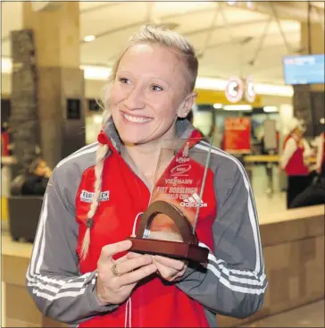  ?? Leah Hennel/calgary Herald ?? Canada’s golden girl of bobsleigh Kaillie Humphries poses with a trophy at the Calgary Internatio­nal Airport.
