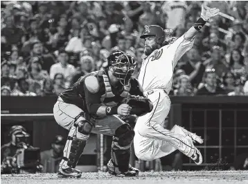  ??  ?? Washington’s Jayson Werth, right, slides into home to score as Atlanta catcher A.J. Pierzynski waits for the throw during the sixth inning of Saturday’s game. The Nationals beat the Braves 7-6.