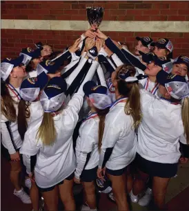  ?? (Photo by Macy Miller) ?? The Gordon Lee squad, led by nine seniors, hoists the championsh­ip trophy following the competitio­n.