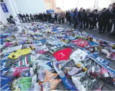  ?? EPA ?? Flowers, scarves, football shirts and tributes have been left outside the King Power Stadium in Leicester