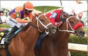  ?? (The Sentinel-Record/Richard Rasmussen) ?? Jockey Irad Ortiz Jr. and Letruska (right) put a head in front of jockey Florent Geroux and Monomoy Girl at the wire to win the Apple Blossom Handicap on Saturday at Oaklawn in Hot Springs.
