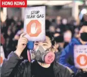  ??  ?? (Top-l)policemen use slingshots to fire stones towards protesters in Baghdad, (Top-r) Demonstrat­ors clash with a riot police vehicle in Santiago; (Bottom-l) Policemen stand ready as protestors run away from tear gas in Paris; A protester during a rally in Hong Kong. AGENCIES