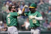  ?? PAUL SANCYA — THE ASSOCIATED PRESS ?? The Oakland Athletics' Seth Brown (15) celebrates his two-run home run with Jed Lowrie (8) against the Detroit Tigers in the eighth inning Thursday in Detroit.