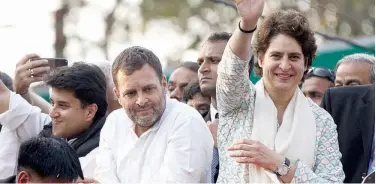  ?? Agence France-presse ?? Rahul Gandhi looks on at a political rally as Priyanka Gandhi Vadra waves to supporters in Lucknow, recently.