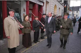  ??  ?? Minister Paul Kehoe inspecting the Enniscorth­y Re-enactmen Society’s guard of honour outside the Athenaeum.